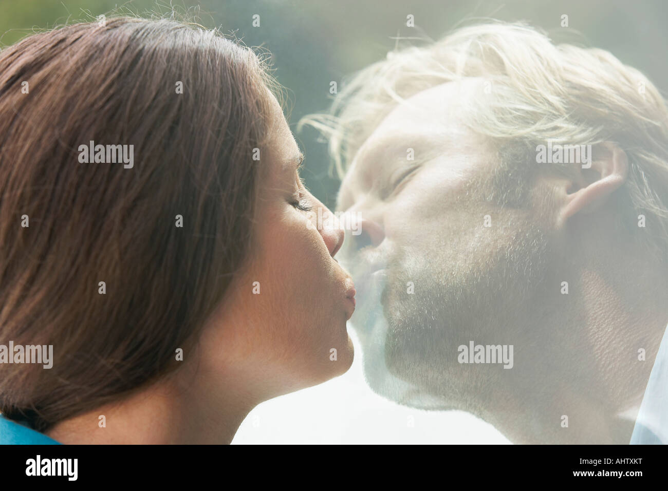 Young couple kissing through glass of window Stock Photo - Alamy