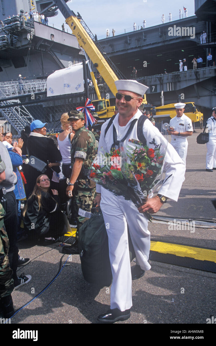 United States sailor arriving home with roses Stock Photo