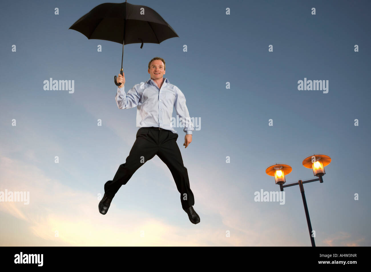 Businessman floating with an umbrella Stock Photo
