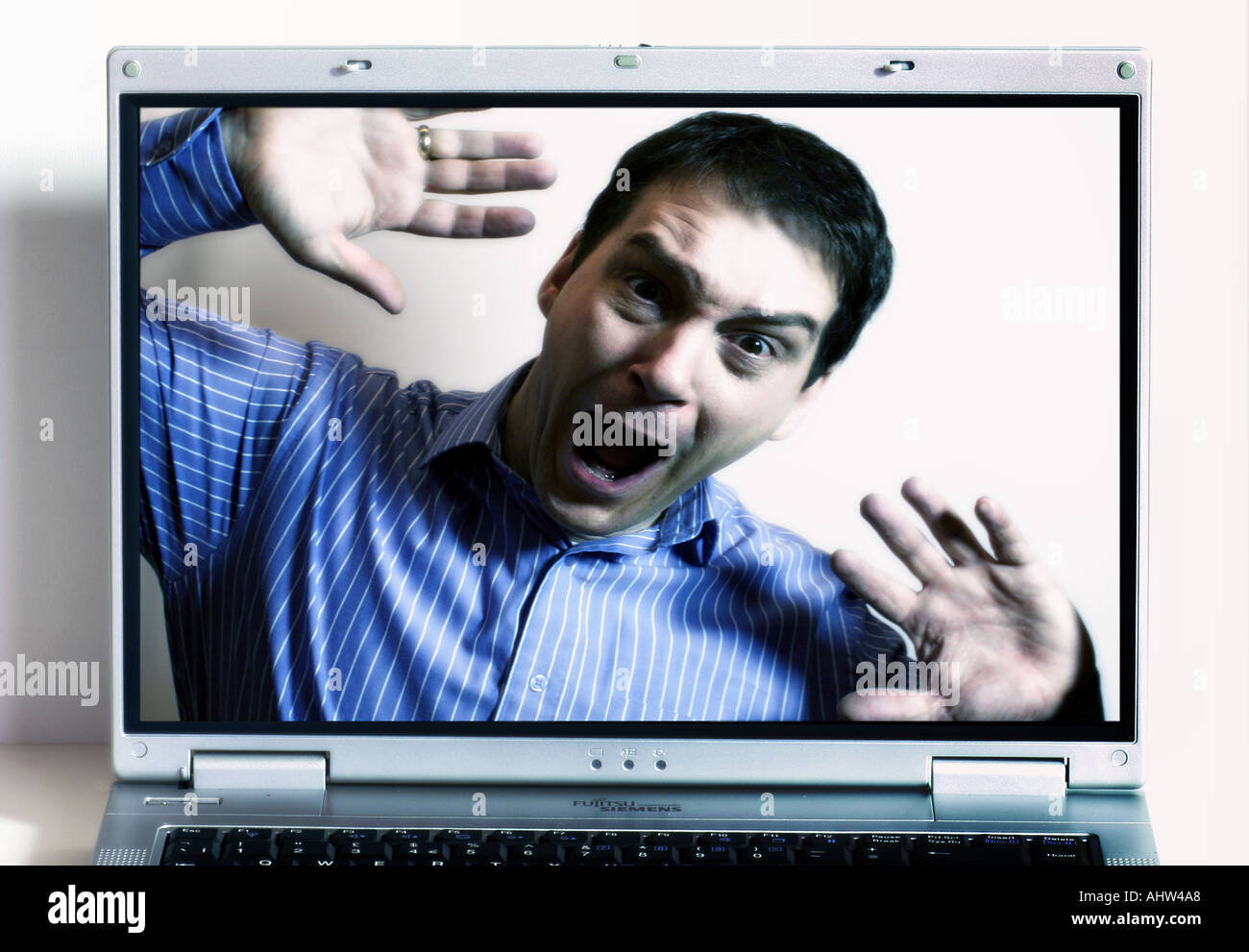 Composite showing man behind notebook screen Stock Photo