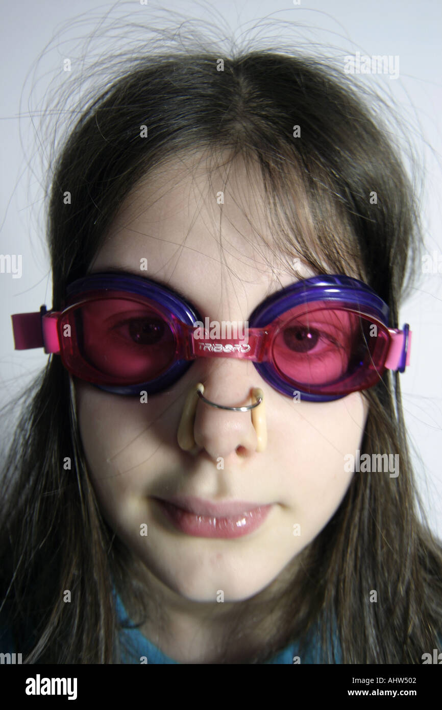 Young girl with goggles and nose clips about to go swimming Stock Photo -  Alamy