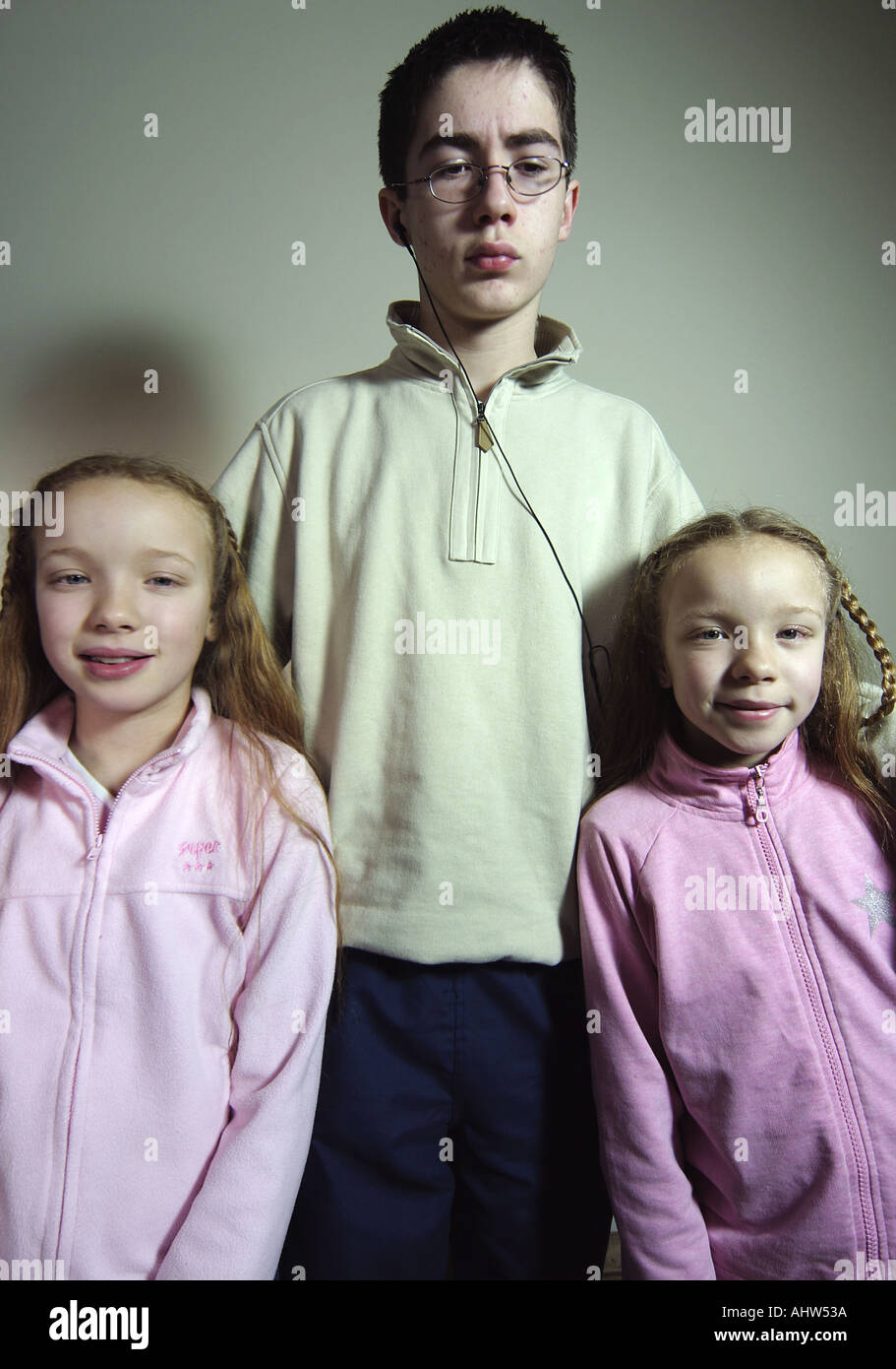 Reluctant Boy Teenager Poses With Twin Girls Stock Photo Alamy Reluctant Boy Teenager Poses With Twin Girls Stock Photo Alamy