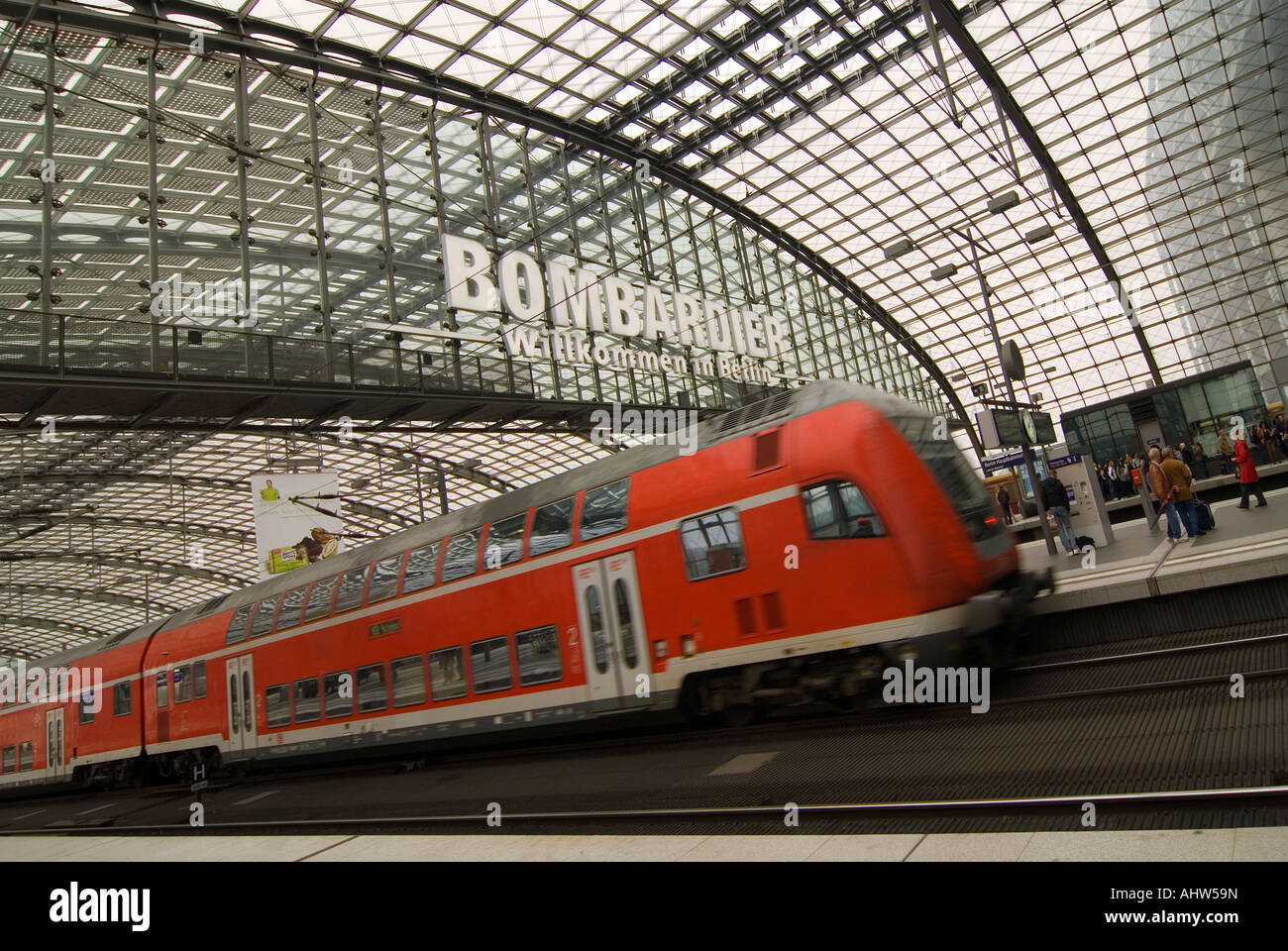 Horizontal wide angle of a double-decked RegionalExpress train approaching a platform at Berlin Hauptbahnhof station. Stock Photo