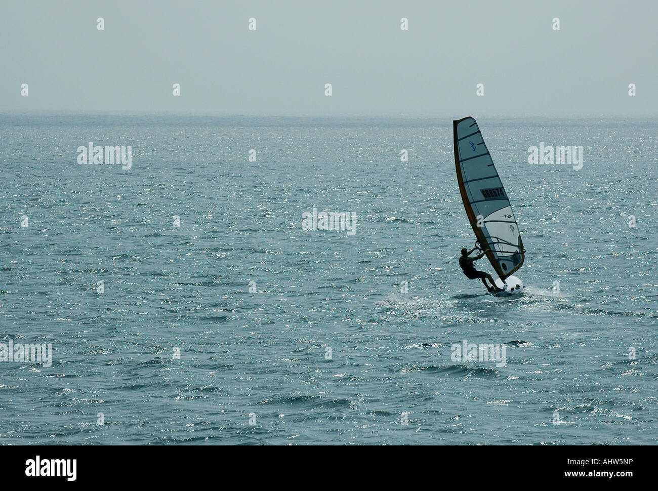 A Windsurfer heading out to Sea Stock Photo