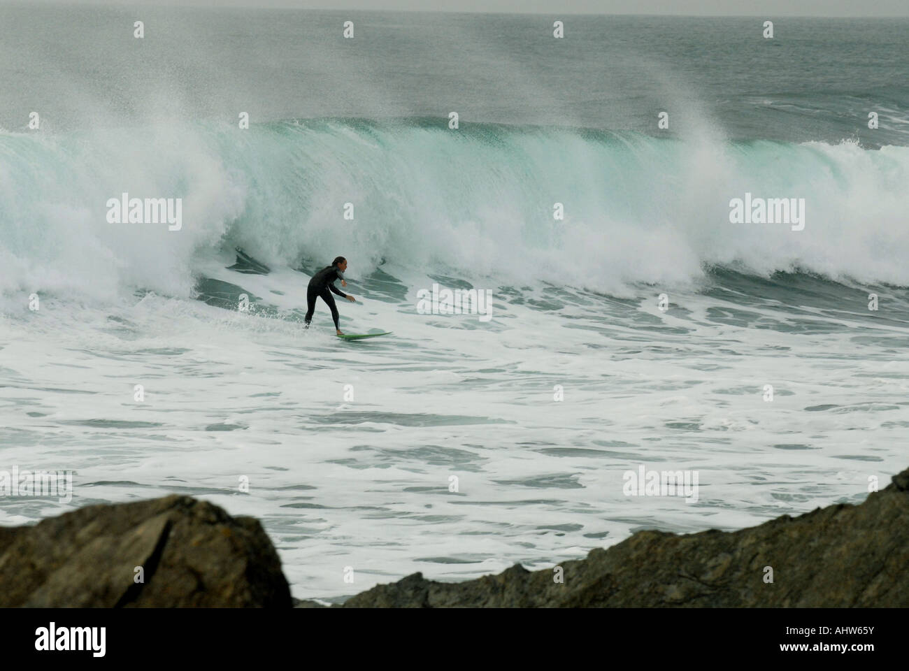 Surfer riding a wave at Newquay, Cornwall Stock Photo - Alamy