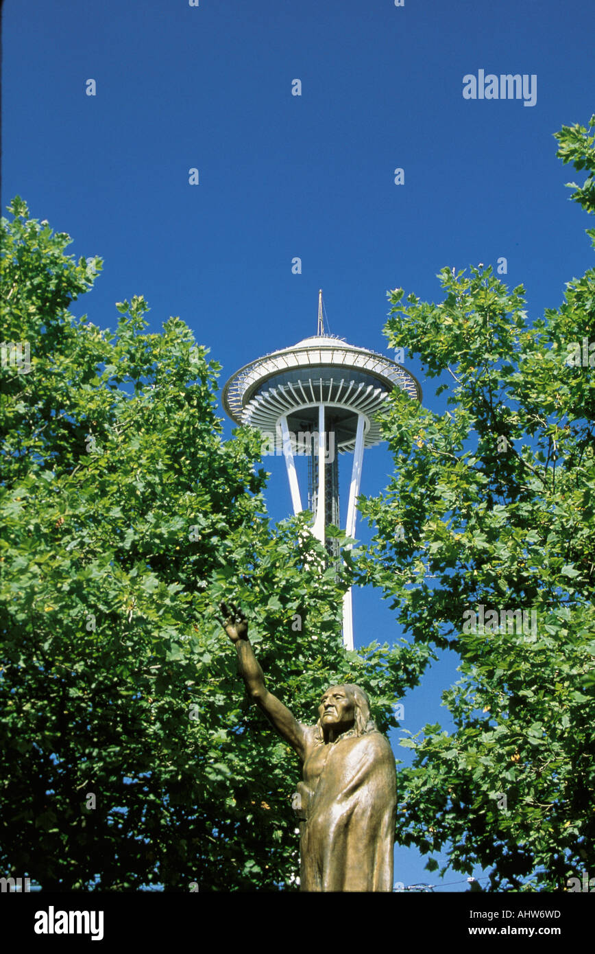 This is a statue of Chief Seattle in front of the Space Needle There is