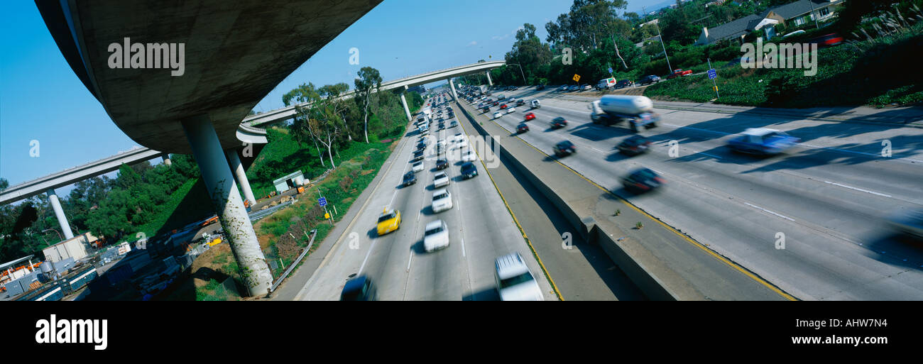 This is the Interstate 405 and 10 at rush hour There are many cars lined up on the freeway with an overpass on the left hand Stock Photo