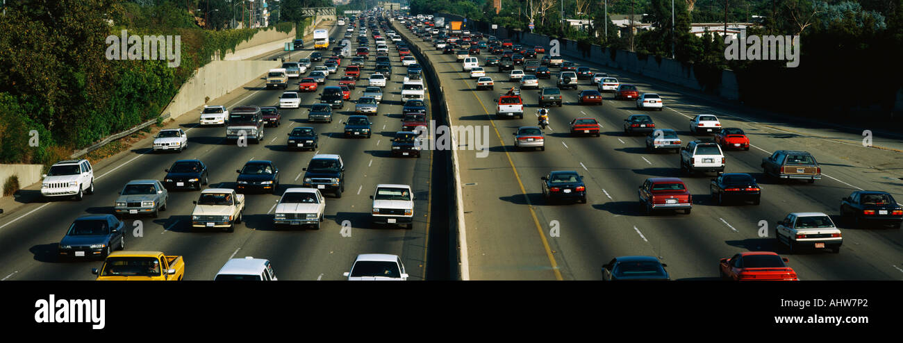 This is rush hour traffic on the 405 Freeway at sunset There are 10 total lanes of traffic with cars traveling in both Stock Photo