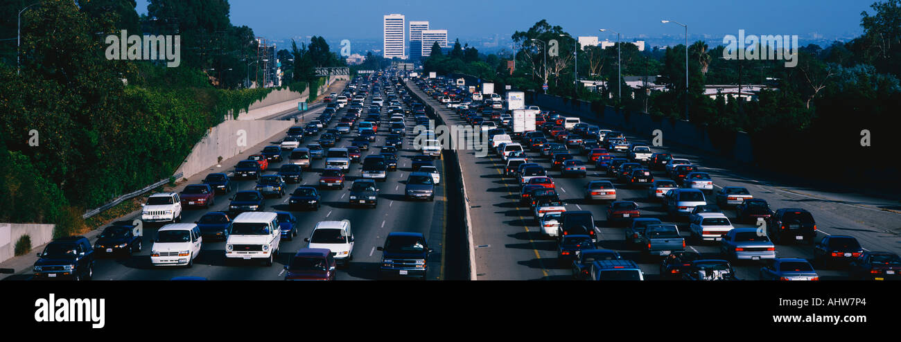 This is rush hour traffic on the 405 Freeway at sunset There are 10 lanes of traffic total showing both sides of the freeway Stock Photo