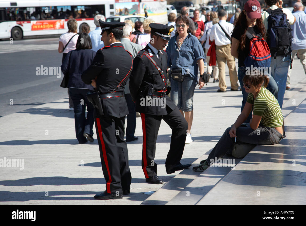 Two Italian Carabinieri police officers chat to pretty italian female tourist on steps in Piazza Venezia Rome Lazio Italy Stock Photo