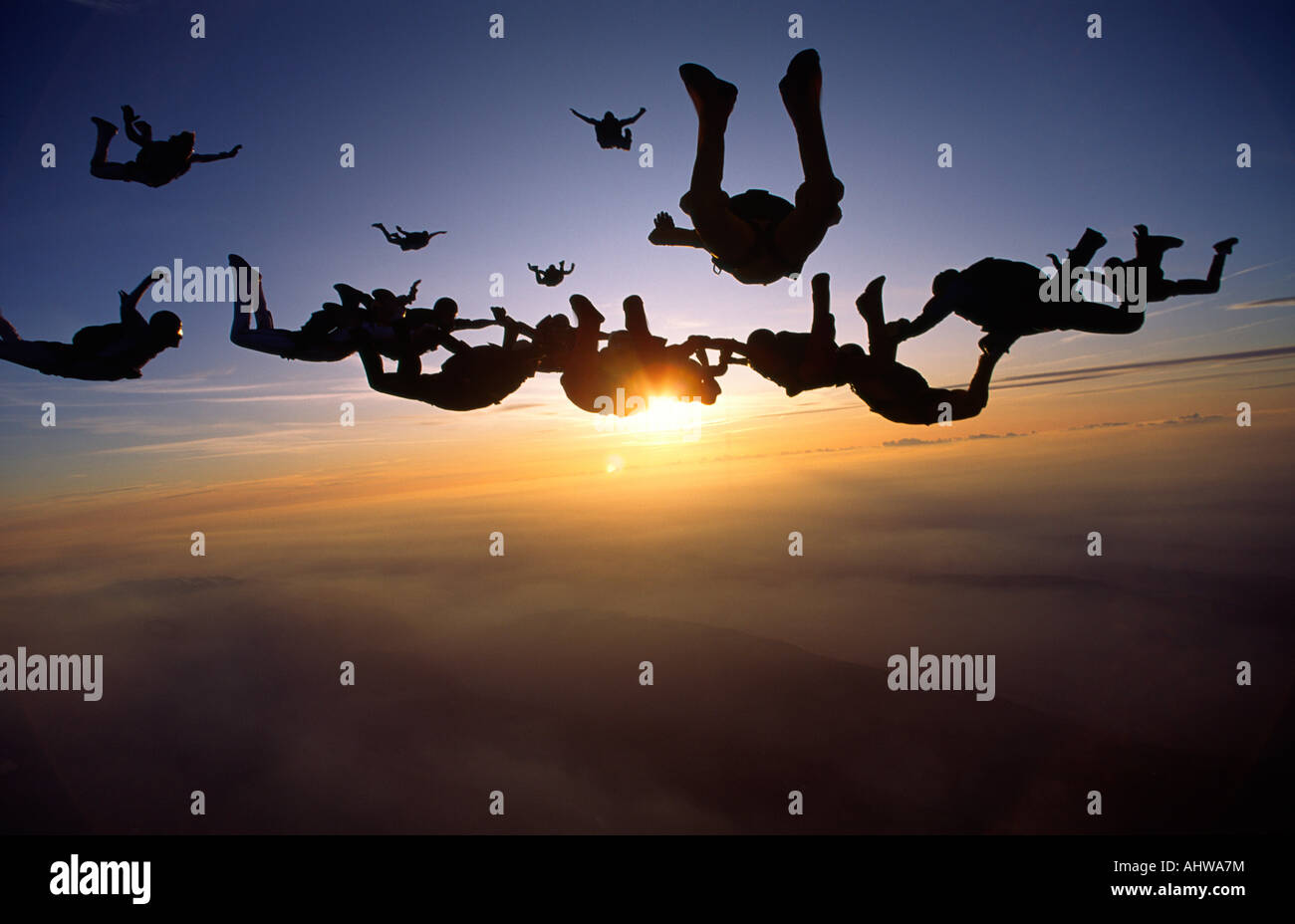 Skydivers are coming together during a sunset Skydive in Switzerland Stock Photo