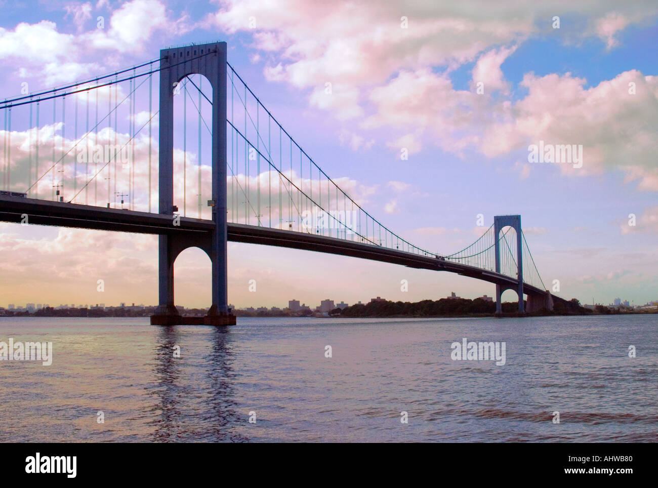 Whitestone Bridge NYC USA in daytime shot horizontally including the river water below with NYC skyline in background Stock Photo
