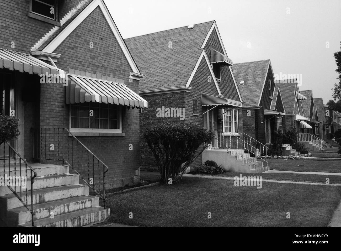 This is a black and white image of a row of single family houses They are located on the south side of Chicago They are brick Stock Photo