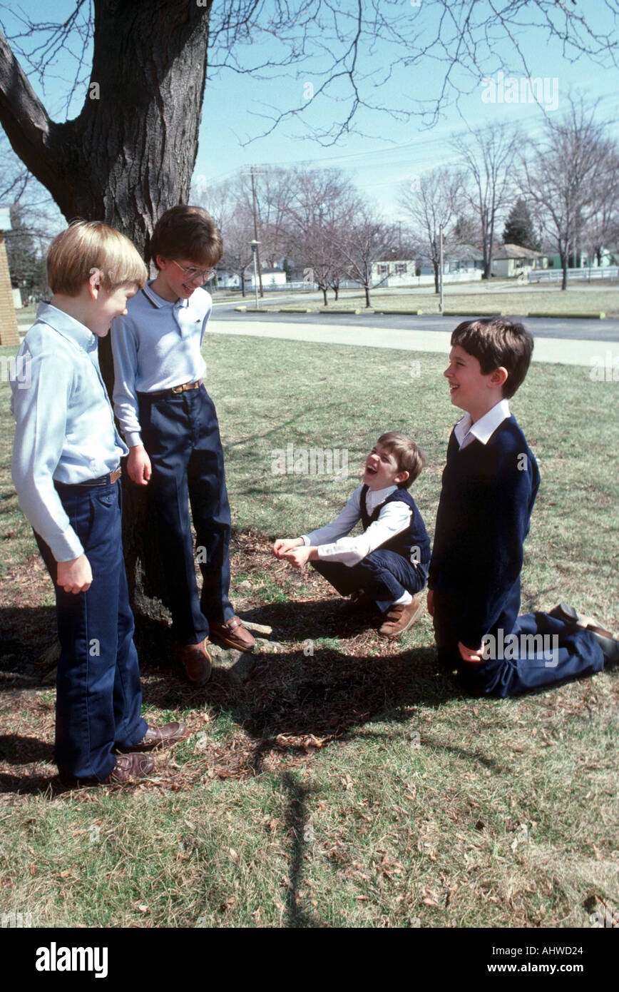 Kræft orange latin 5th grade school boys socialize talk and converse in the school yard Stock  Photo - Alamy