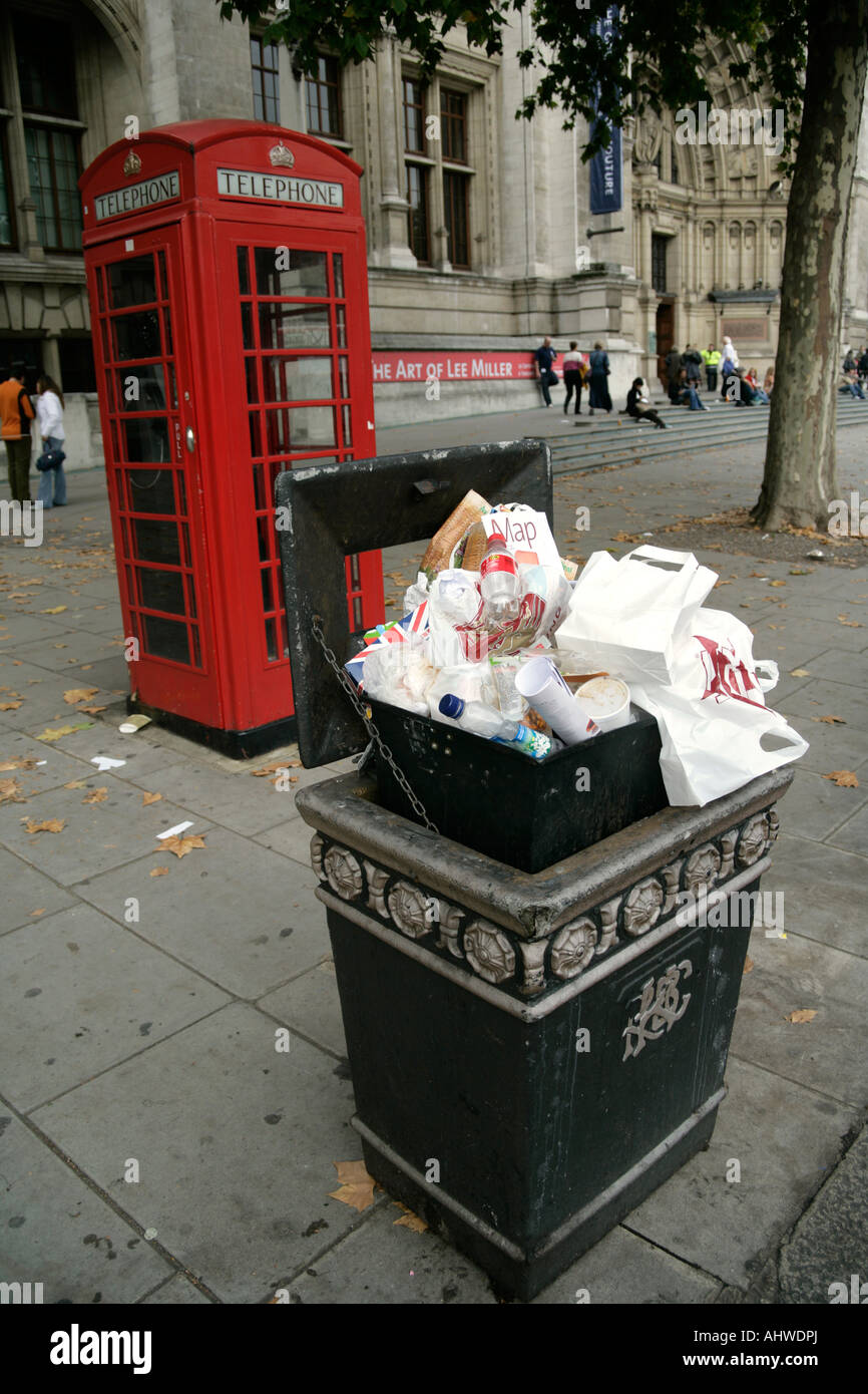 Overflowing rubbish bin awaiting to be emptied by municipal workers