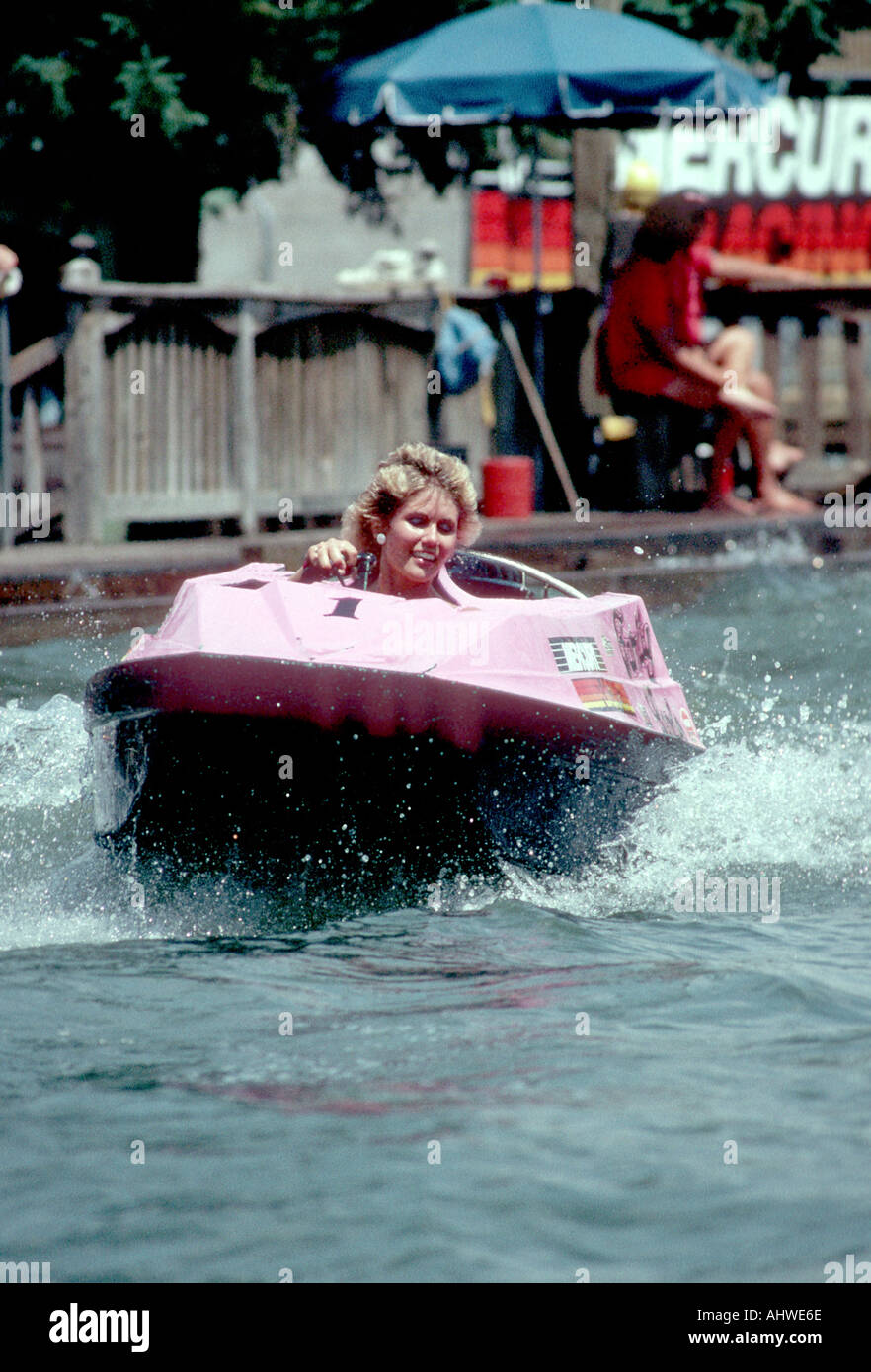 Wisconsin Dells water park female races around a pool in a small boat 3
