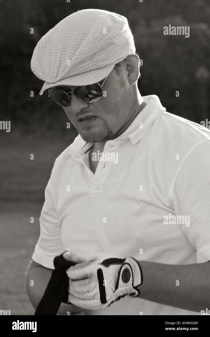 American golf player with golf club sport portrait of a caucasian young man outside b&w image blurry blurred background in USA US vertical hi-res Stock Photo