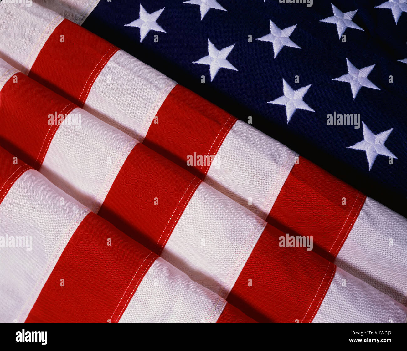 This is a rectangularly shaped folded American flag The field of stars is folded in the shape of an uneven triangle while the Stock Photo