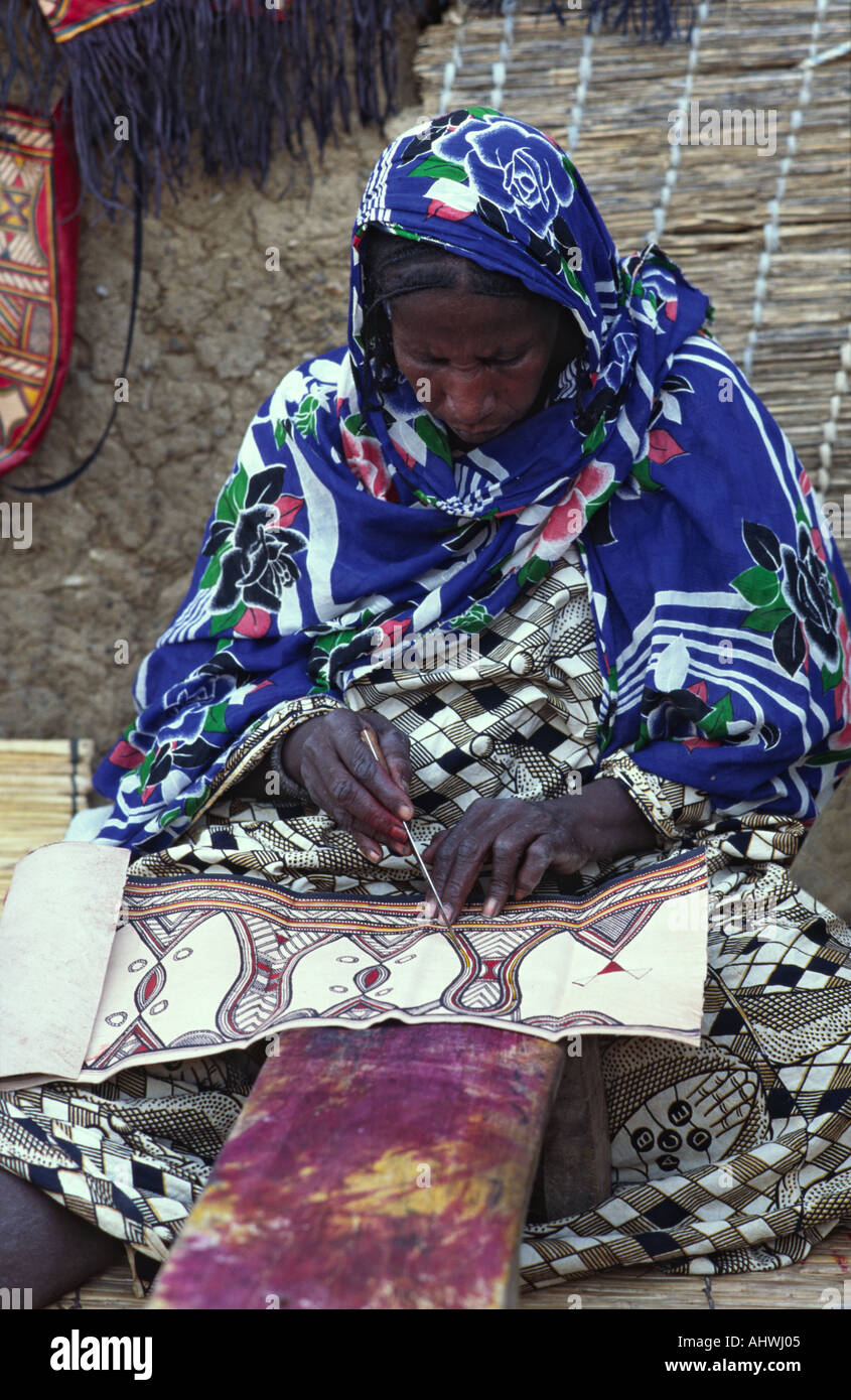Tuareg woman embroidering leather, Burkina Faso, West Africa Stock Photo
