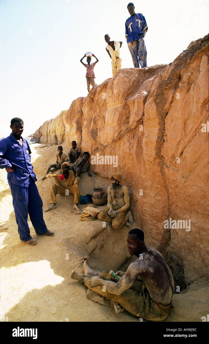 Artisanal goldminers and child labourers having a break. Essakane, Burkina Faso,West Africa Stock Photo