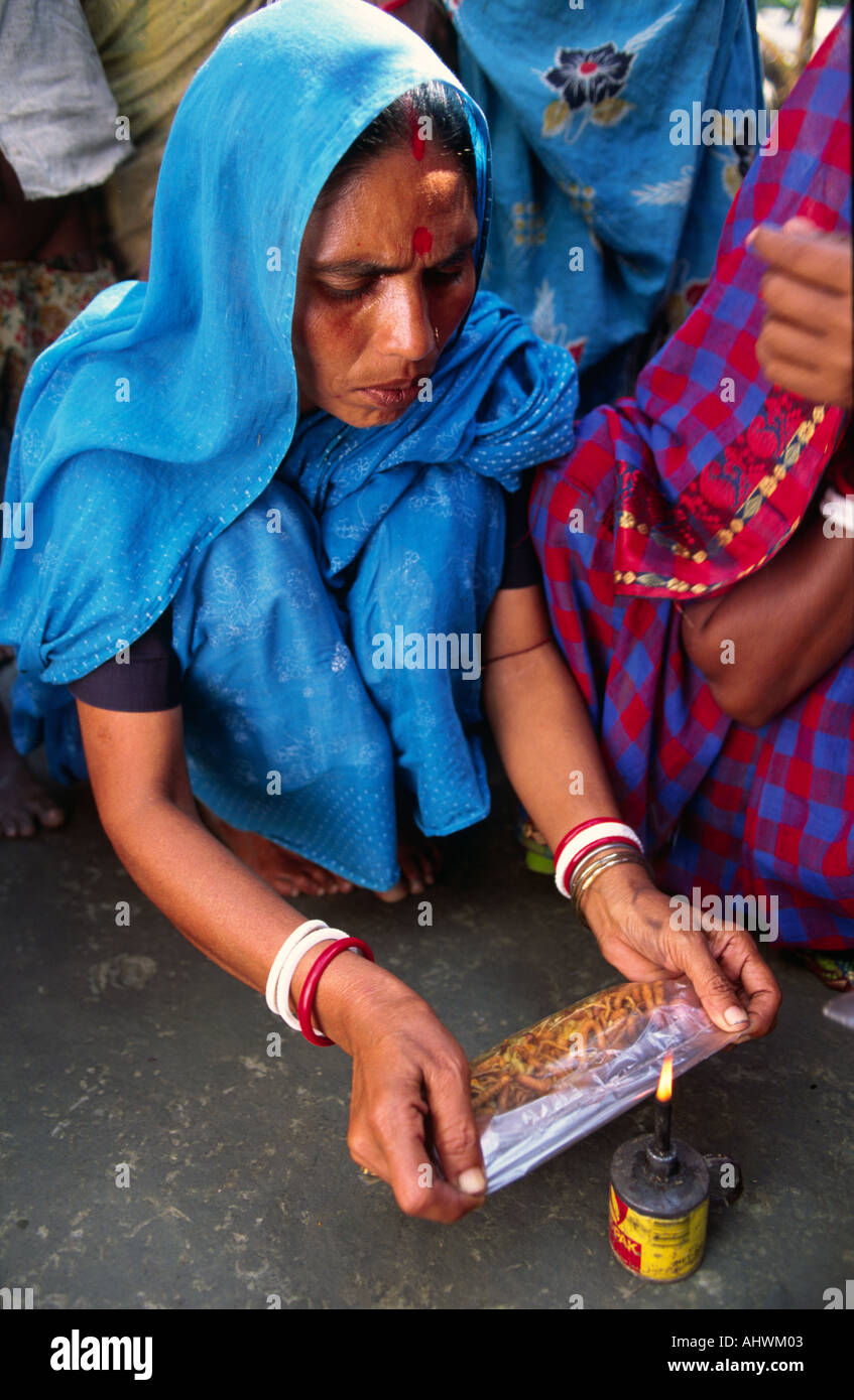 Women's cooperative, income generation scheme, woman making snacks in rural Bangladesh Stock Photo