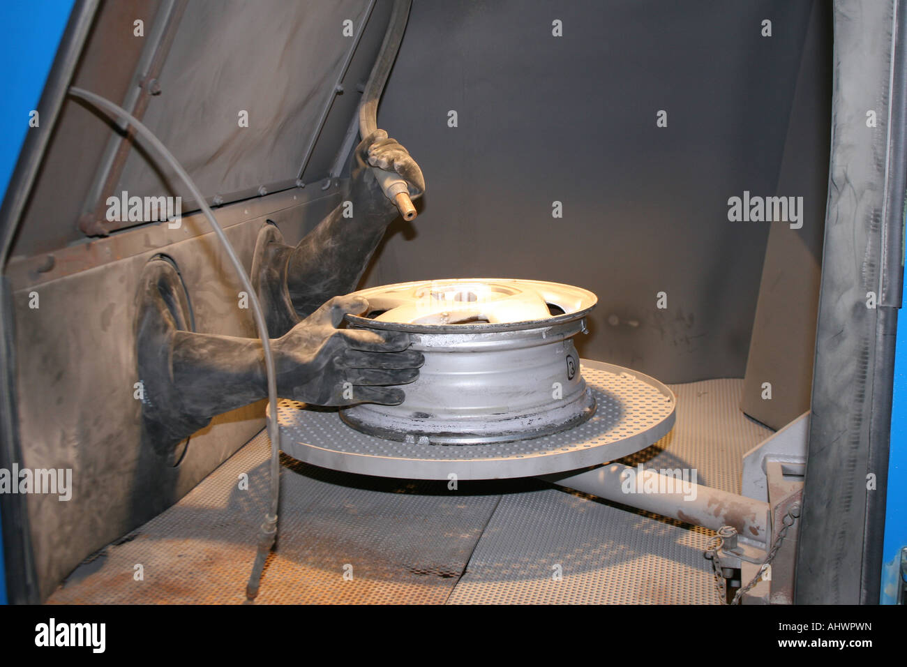 alloy wheel being sand blasted Stock Photo Alamy