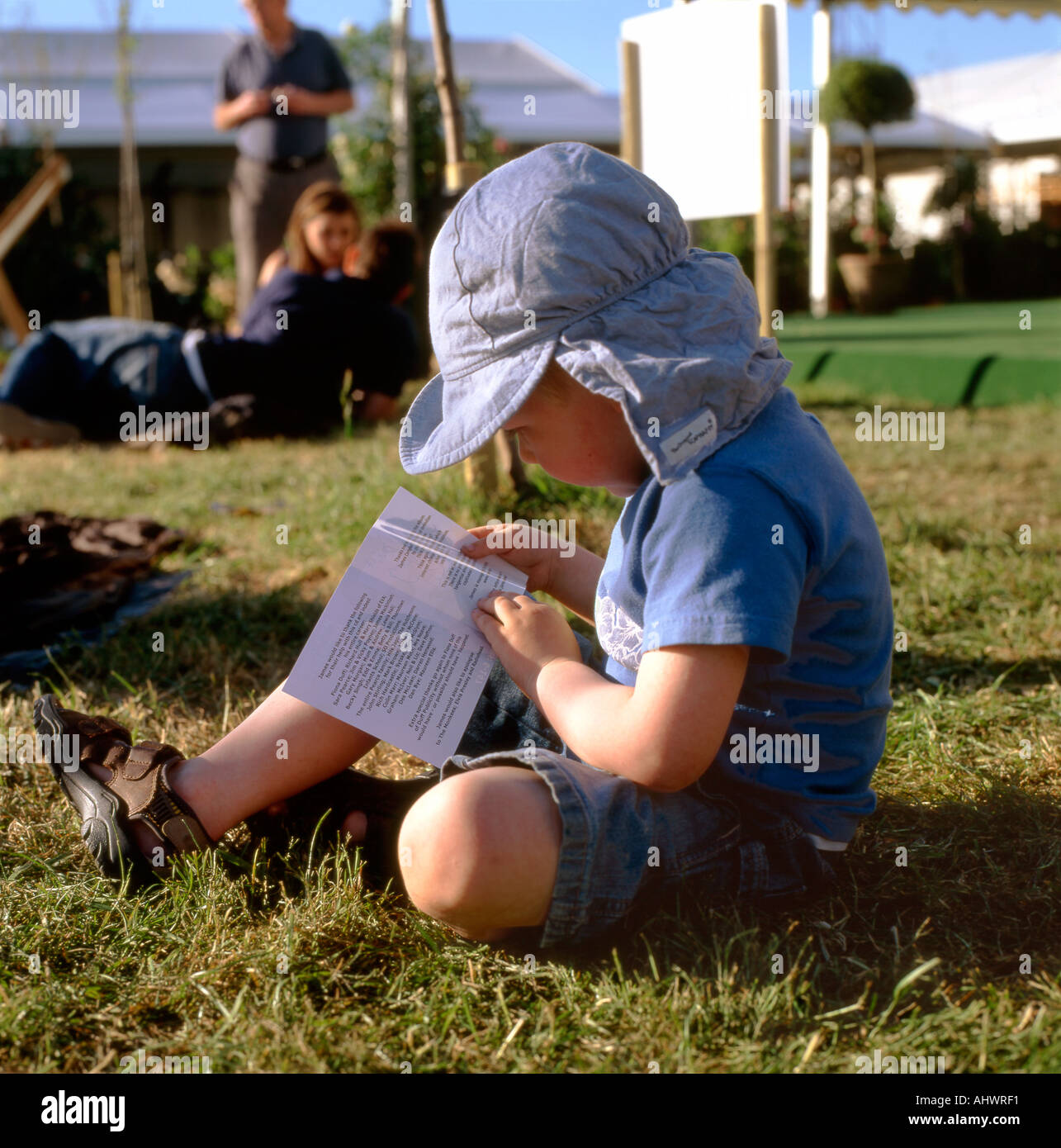 A 3 year old boy reading at the Hay Festival Hay-on-Wye Wales UK    KATHY DEWITT Stock Photo