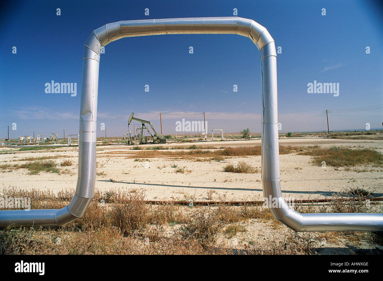 Piping with pump jack in background Stock Photo