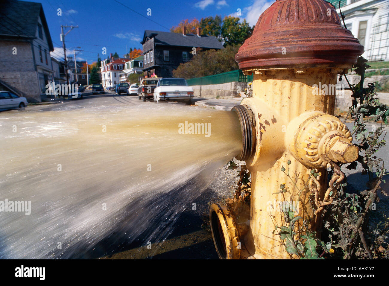 Open fire hydrant shooting water Stock Photo