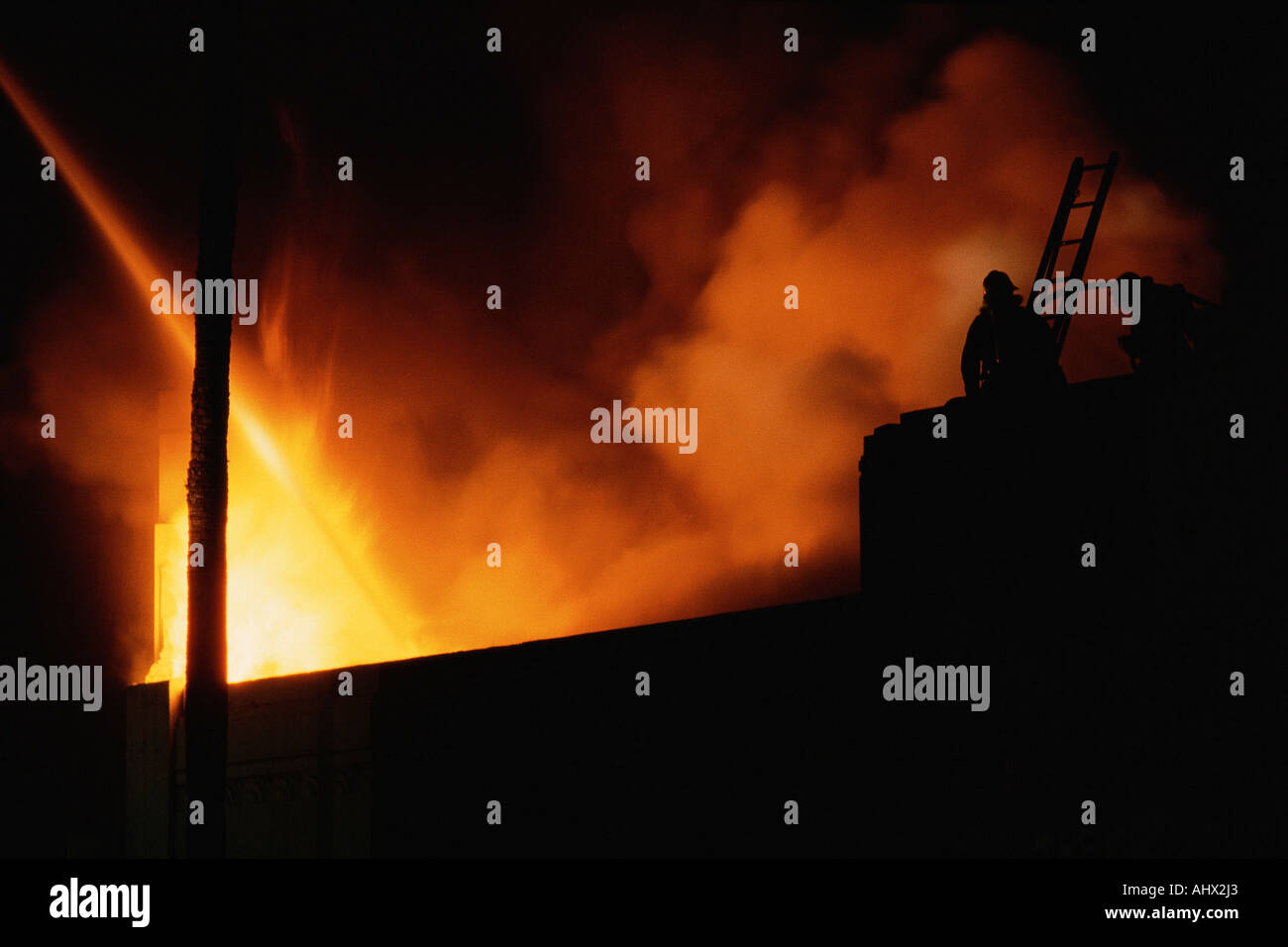 Raging fire against dark skies Stock Photo