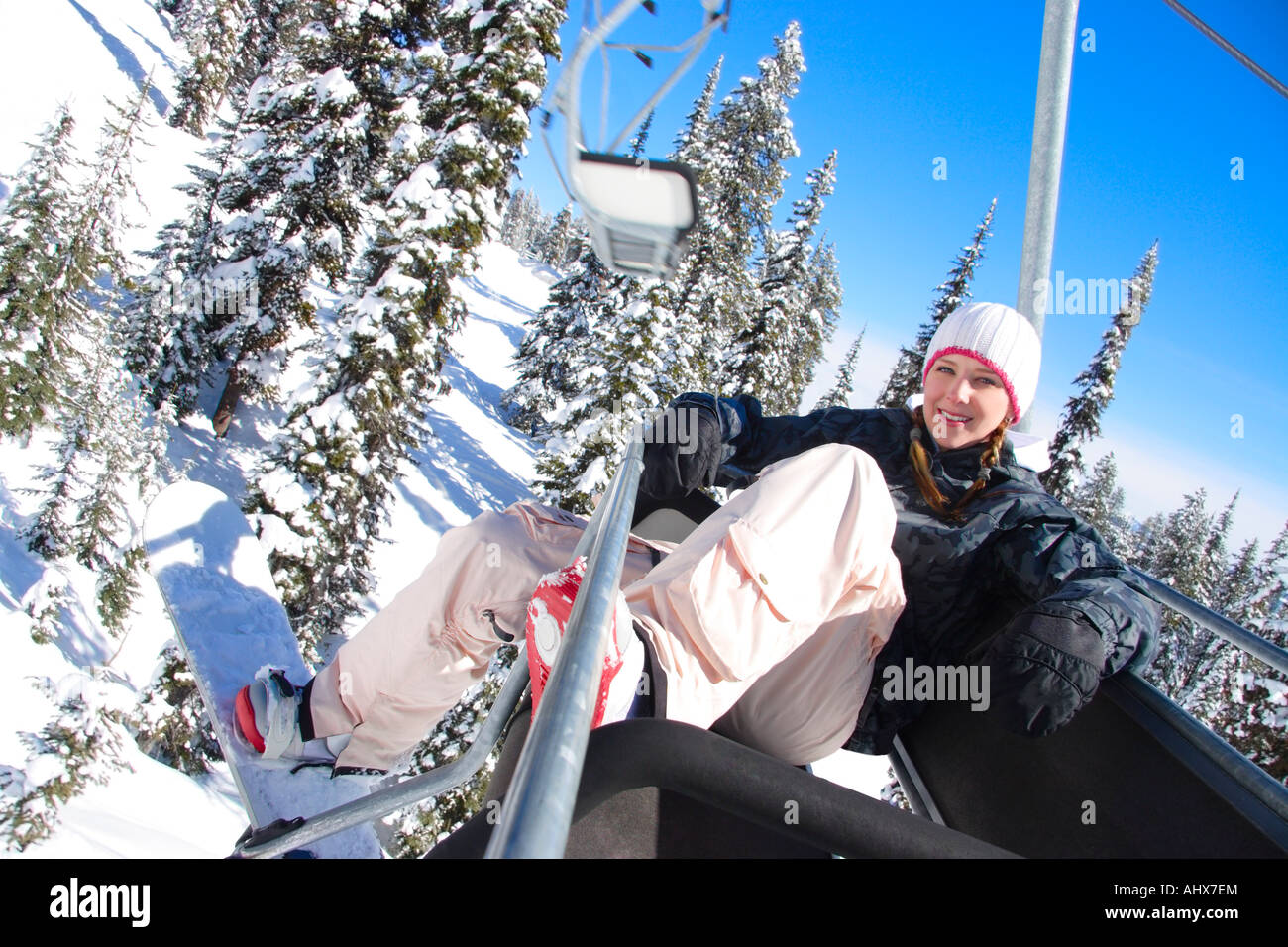 Girl in ski lift on ski hill Stock Photo