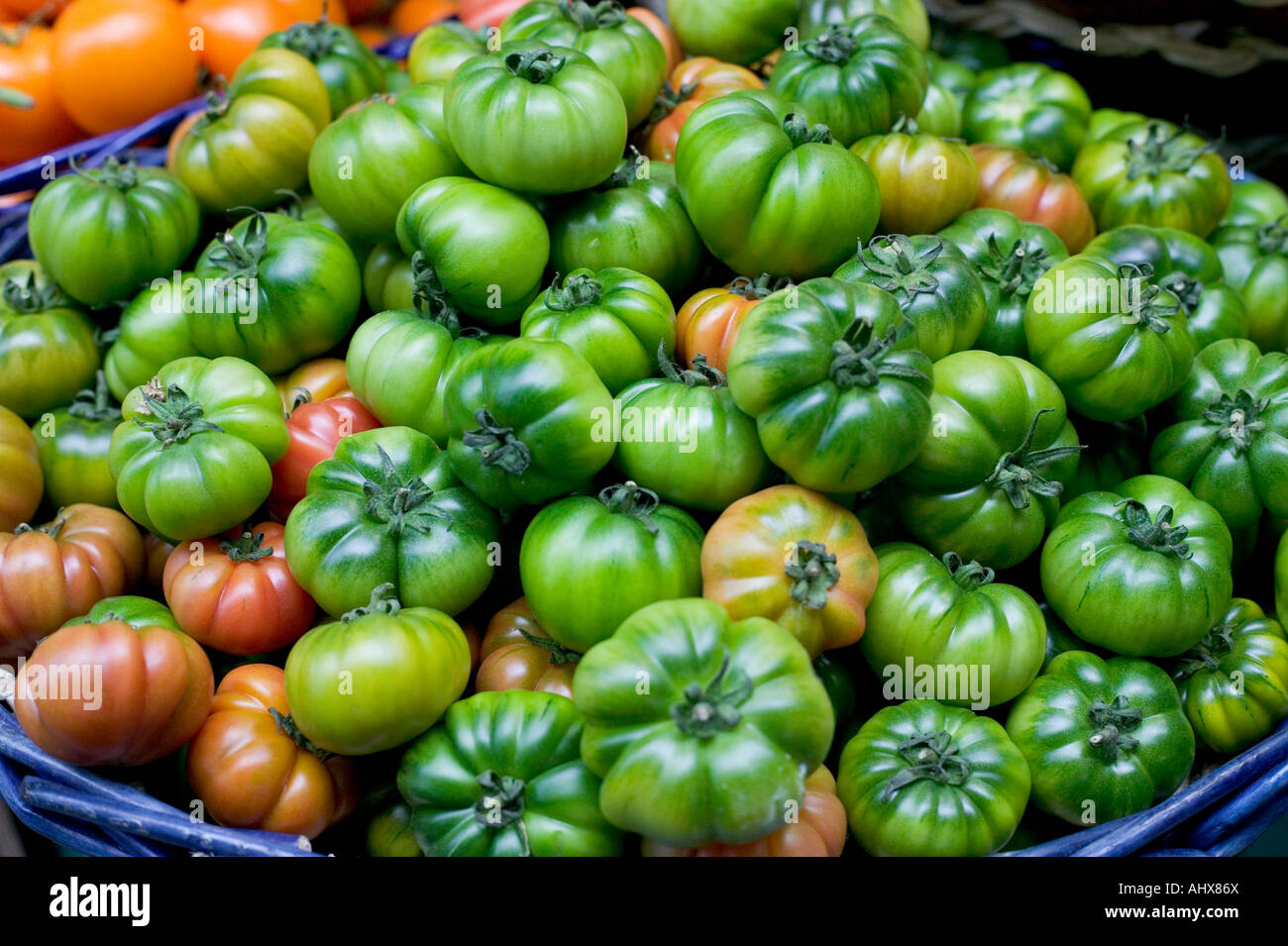 close up of a bowl of green tomatoes at London Borough market Stock Photo