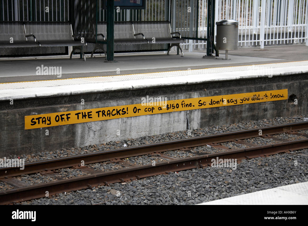 Stay off the Tracks or Cop a 150 fine warning sign on railway station platform in Brisbane Queensland QLD Australia Amusing fun Stock Photo