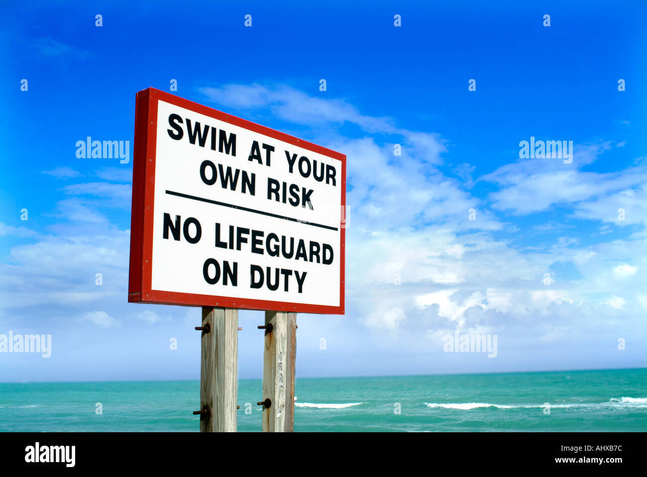 Swim at your own risk sign no lifeguard on duty Stock Photo Alamy