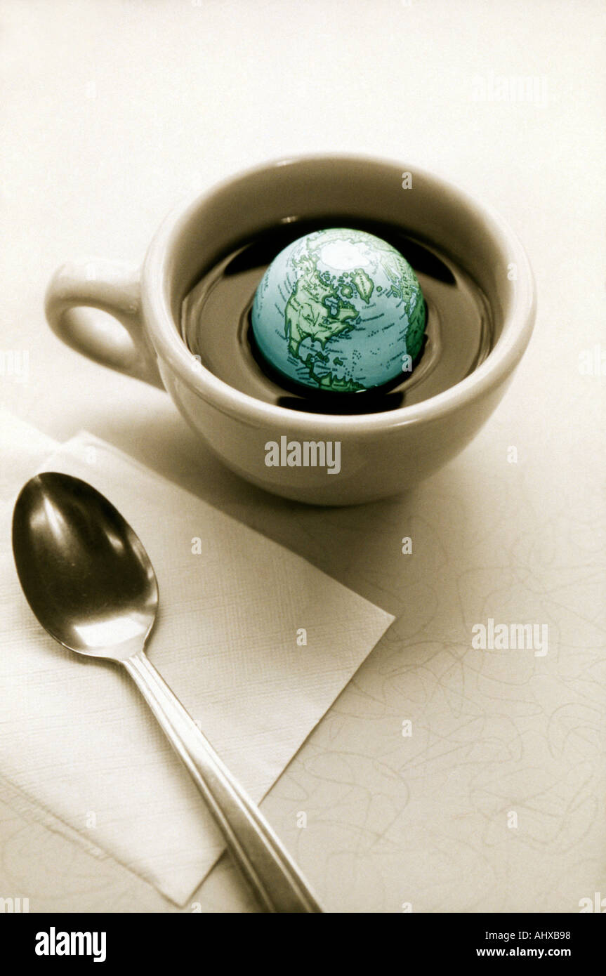 Black and white image of colorized globe floating in cup of coffee Stock Photo