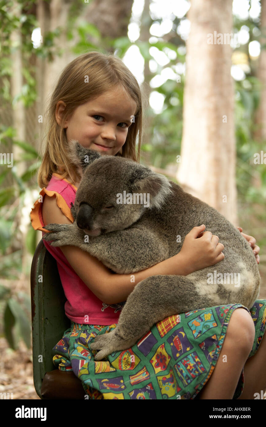 Young girl child holding a Koala bear in Lone Pine Koala Sanctuary