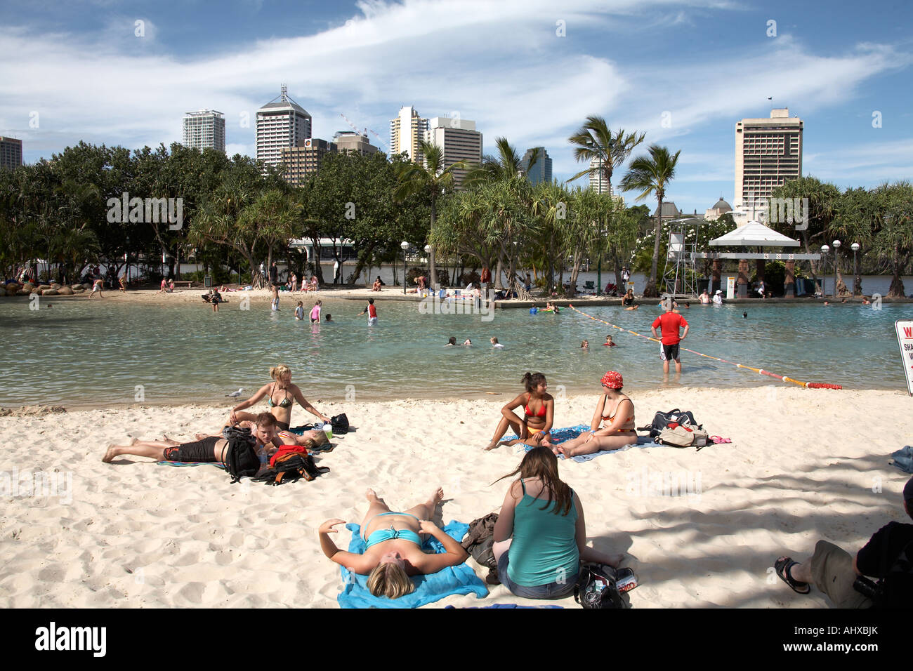 People swimming and sunbathing in summer on artificial Streets beach on South Bank in Brisbane Queensland QLD Australia Stock Photo