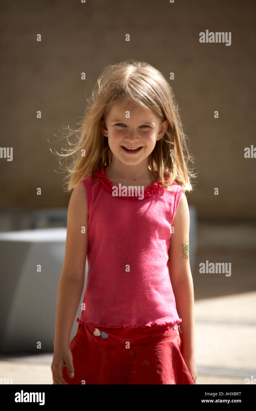 Young girl child smiling in red dress in Brisbane Queensland QLD Australia OD Stock Photo