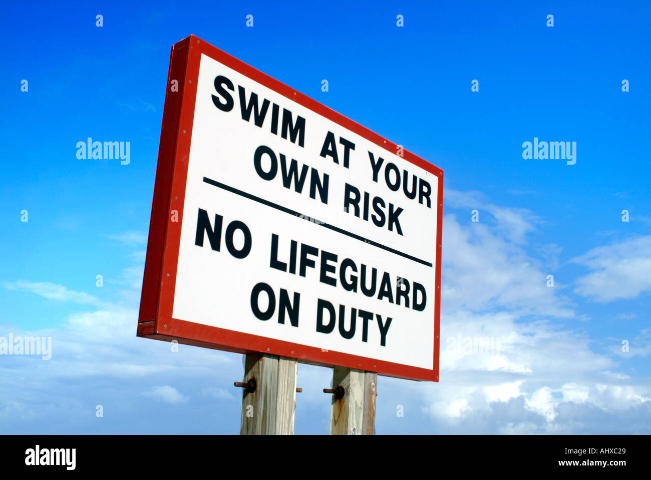 Swim at your own risk sign no lifeguard on duty Stock Photo Alamy