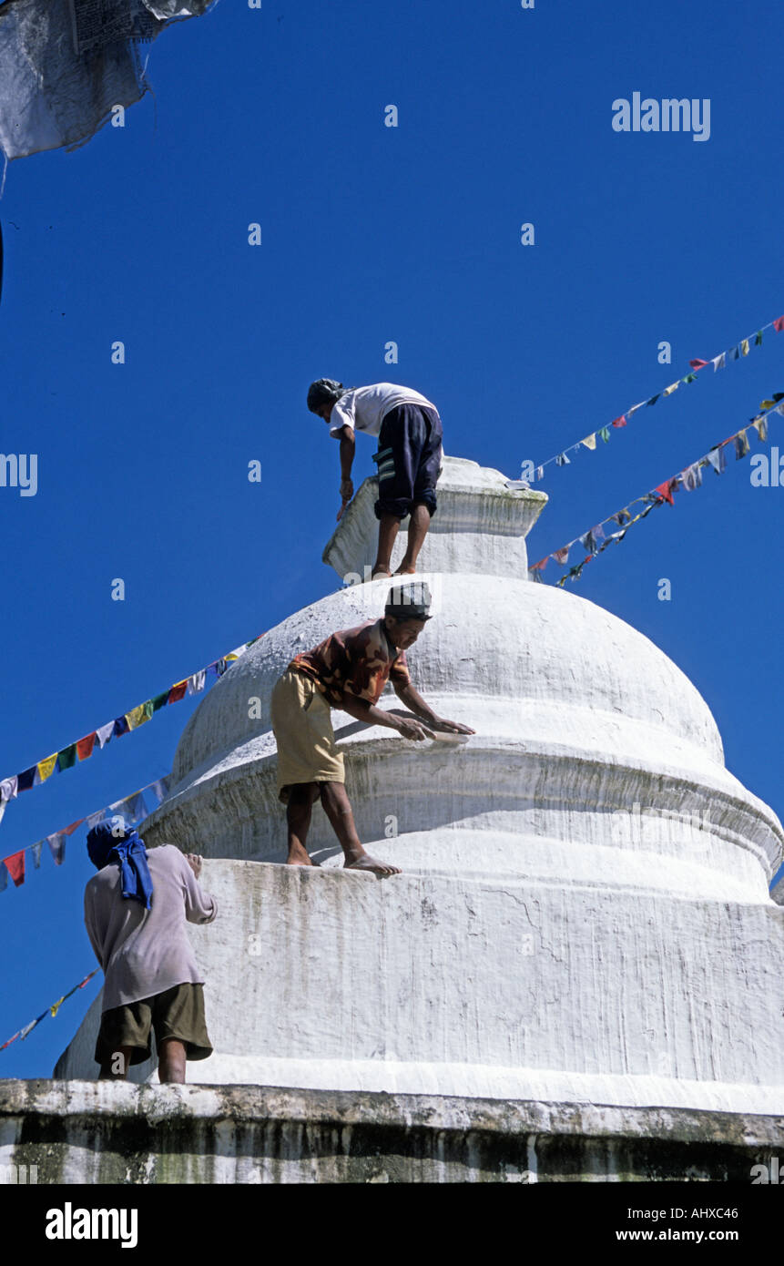Nepali workers clean small stupa at Boudhanath Kathmandu Nepal Stock