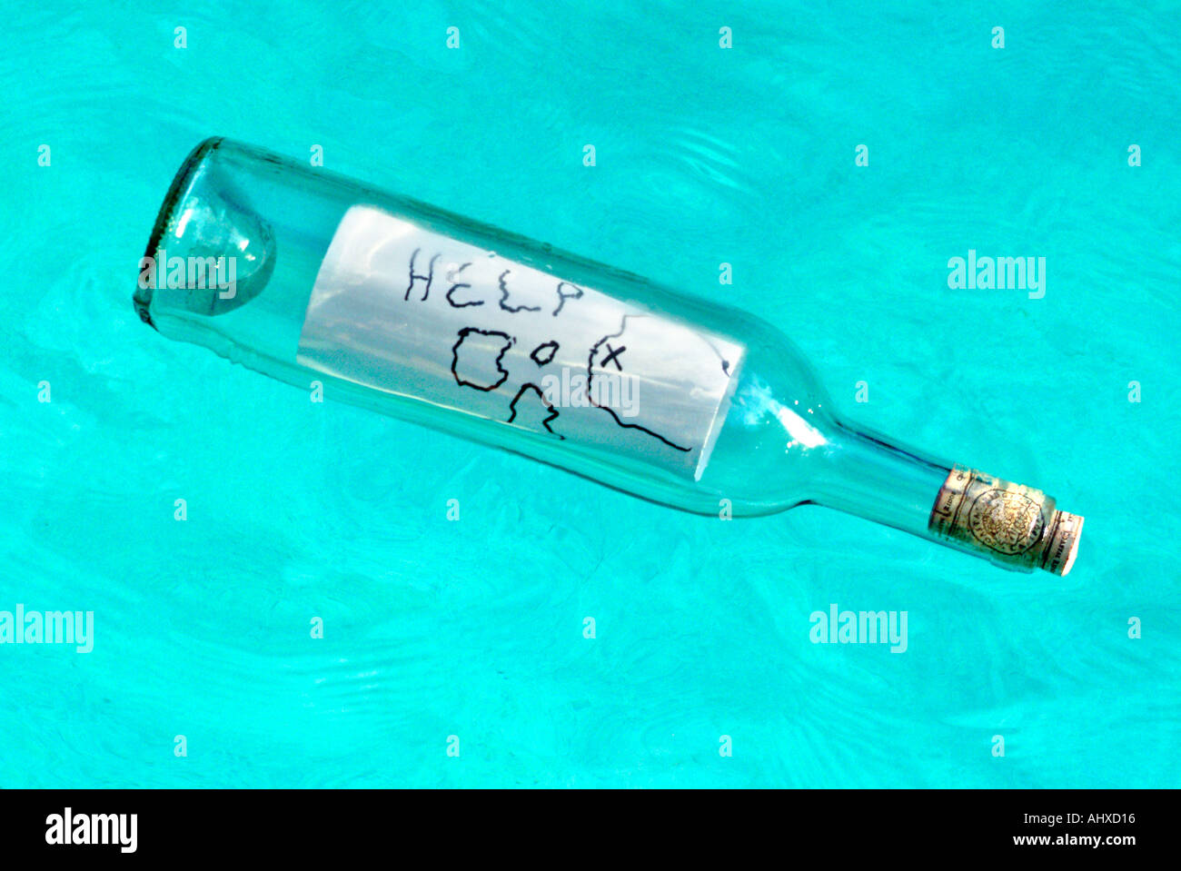 Message in a glass bottle floating in water Stock Photo
