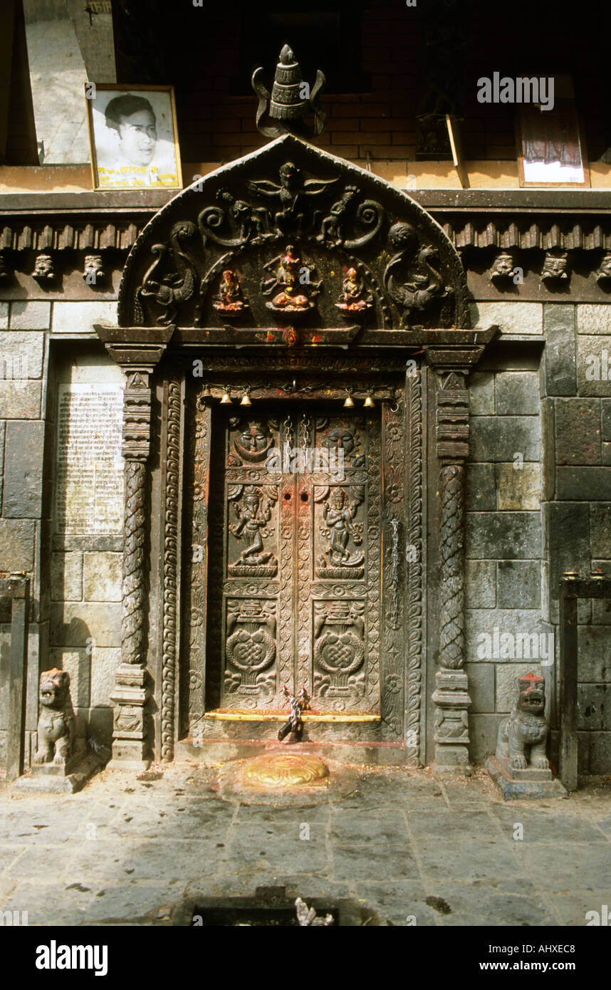Intricately carved wooden doorway of a traditional temple in Kathmandu ...