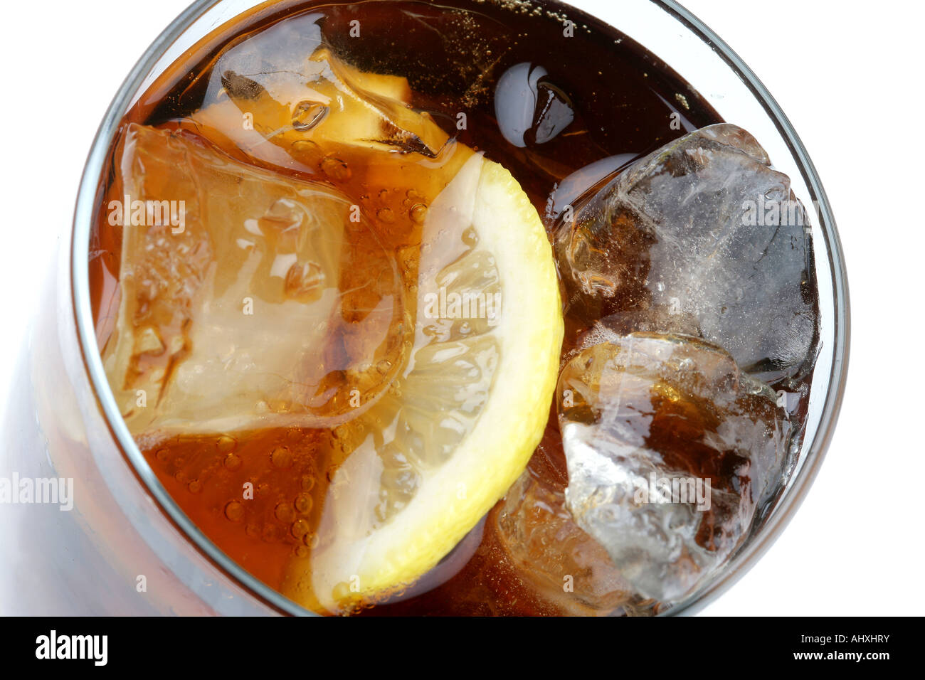 Close Up Of A Glass of Fizzy Soft Drink Cola With Ice And Lemon With No People Stock Photo