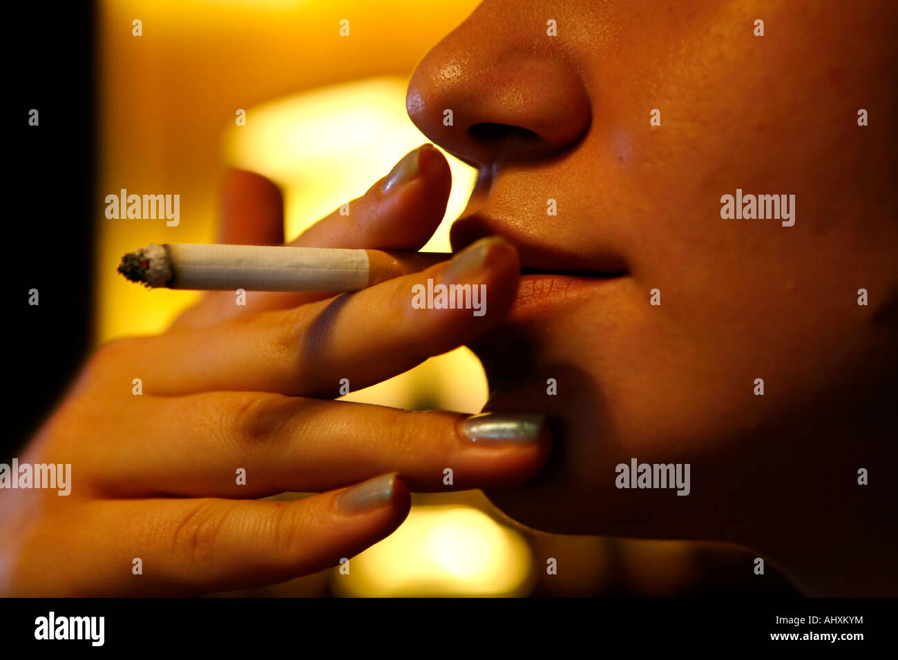 Woman inhaling a cigarette Stock Photo Alamy