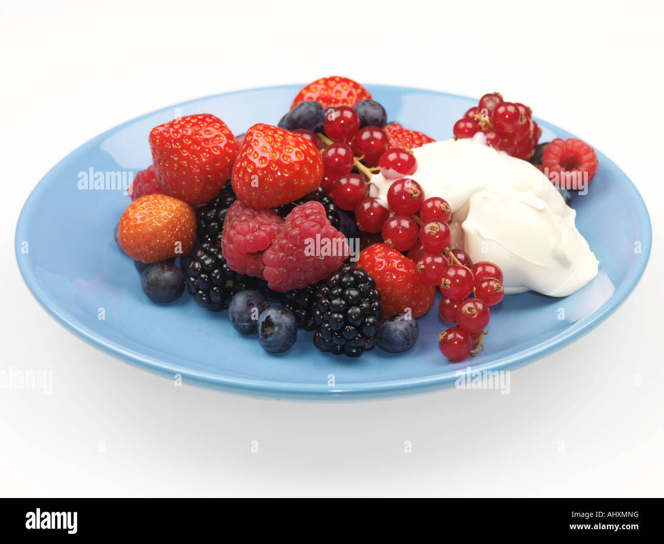 Fresh Ripe Healthy Mixed Fruit Salad With Summer Berries And Fromage Frais Isolated Against A White Background With No People and A Clipping Path Stock Photo