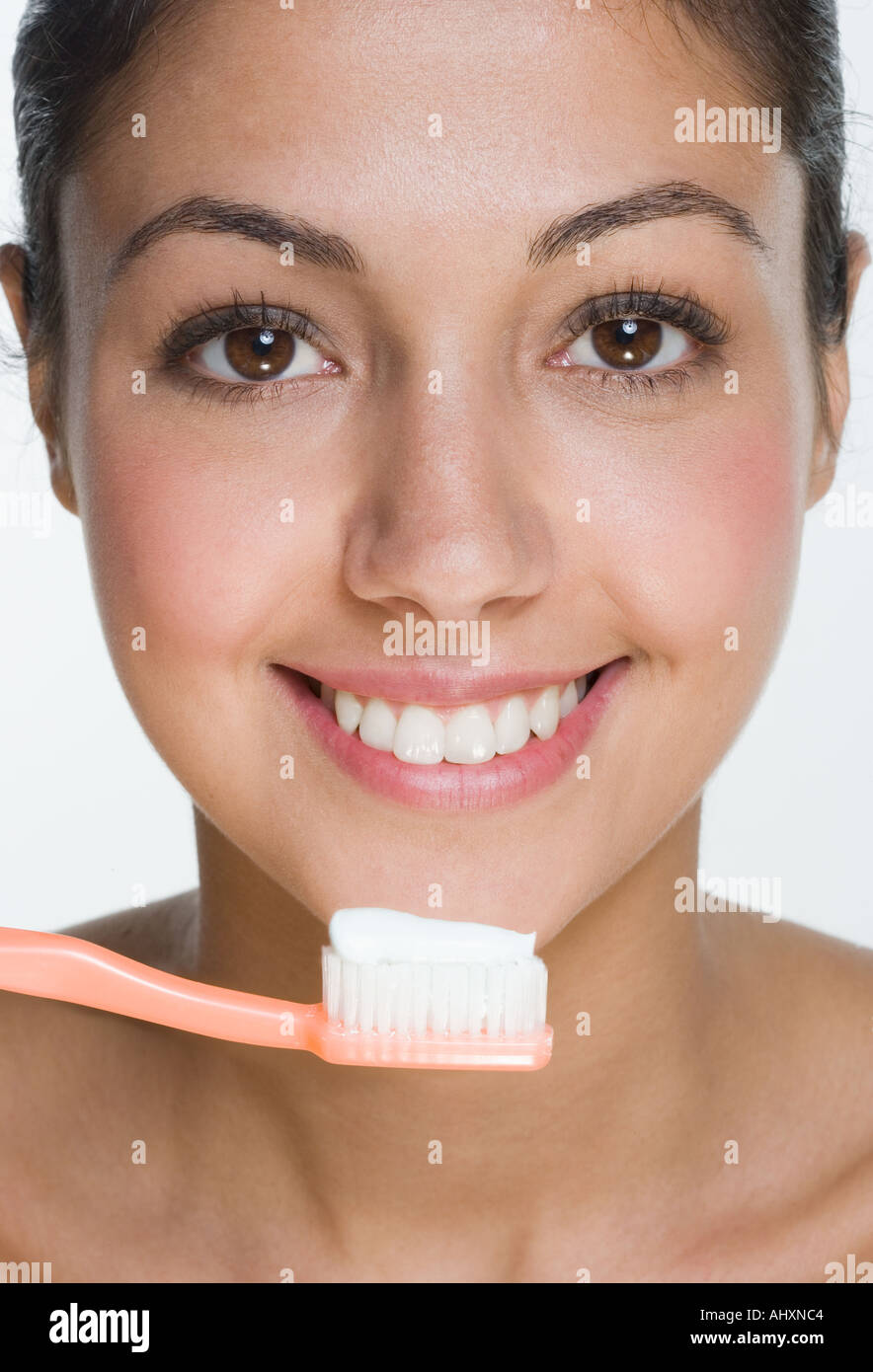 Smiling woman with toothbrush Stock Photo