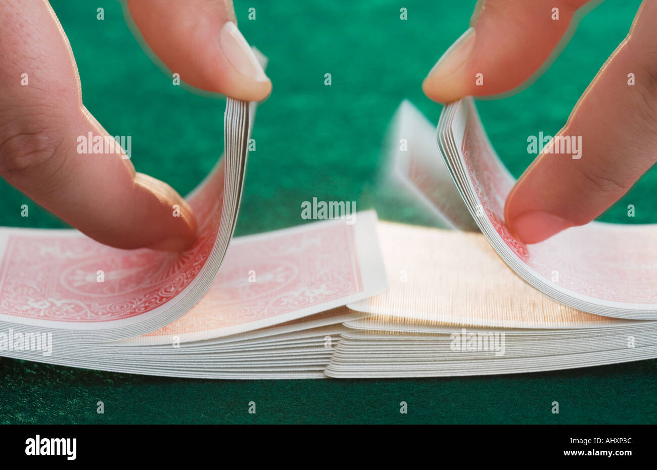Hands shuffling cards on poker table Stock Photo Alamy