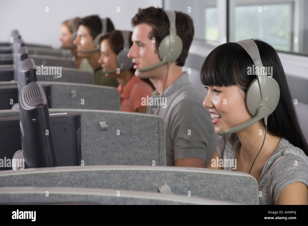 College students wearing headsets in computer lab Stock Photo Alamy
