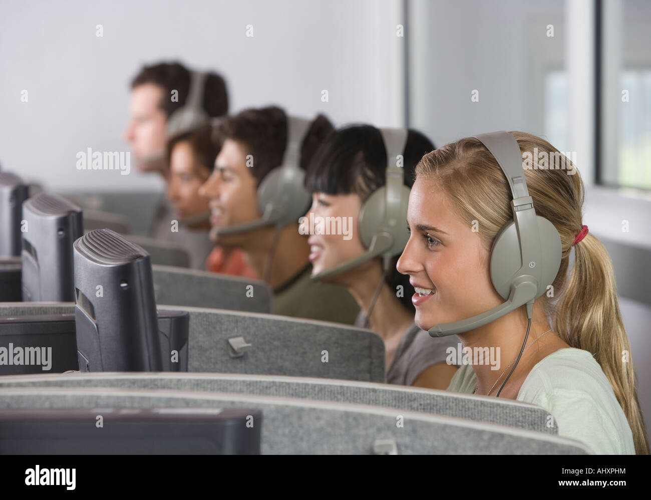 College students wearing headsets in computer lab Stock Photo Alamy