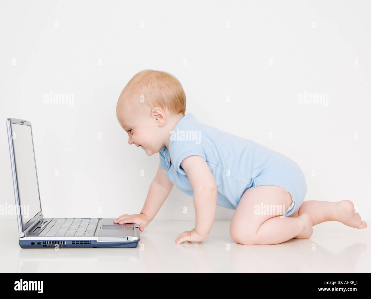 Baby looking at laptop Stock Photo